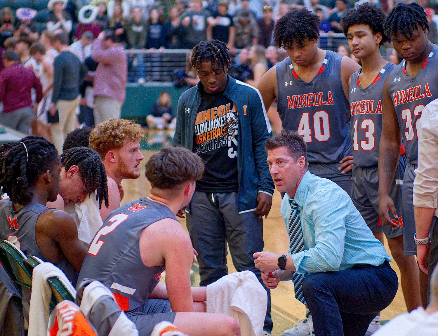 Mineola head coach Ryan Steadman guides the Yellowjackets during a timeout.